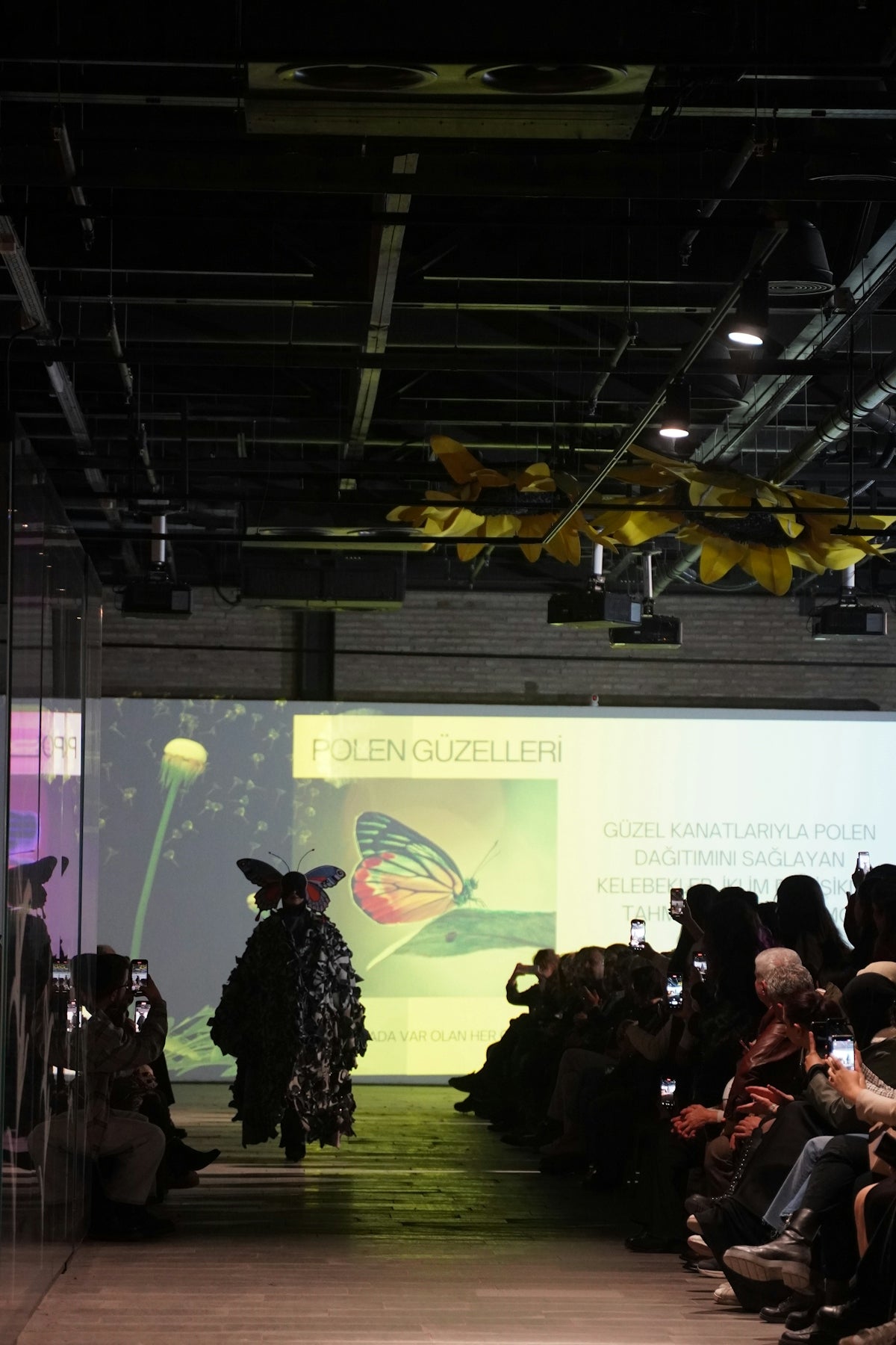 Fashion runway show features unique clothing designs.